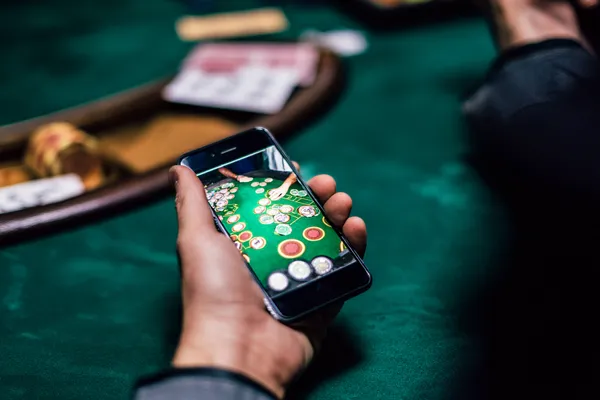 A glowing roulette wheel with cascading chips, symbolizing the engaging live and instant-win games available on ILOTBEF.
